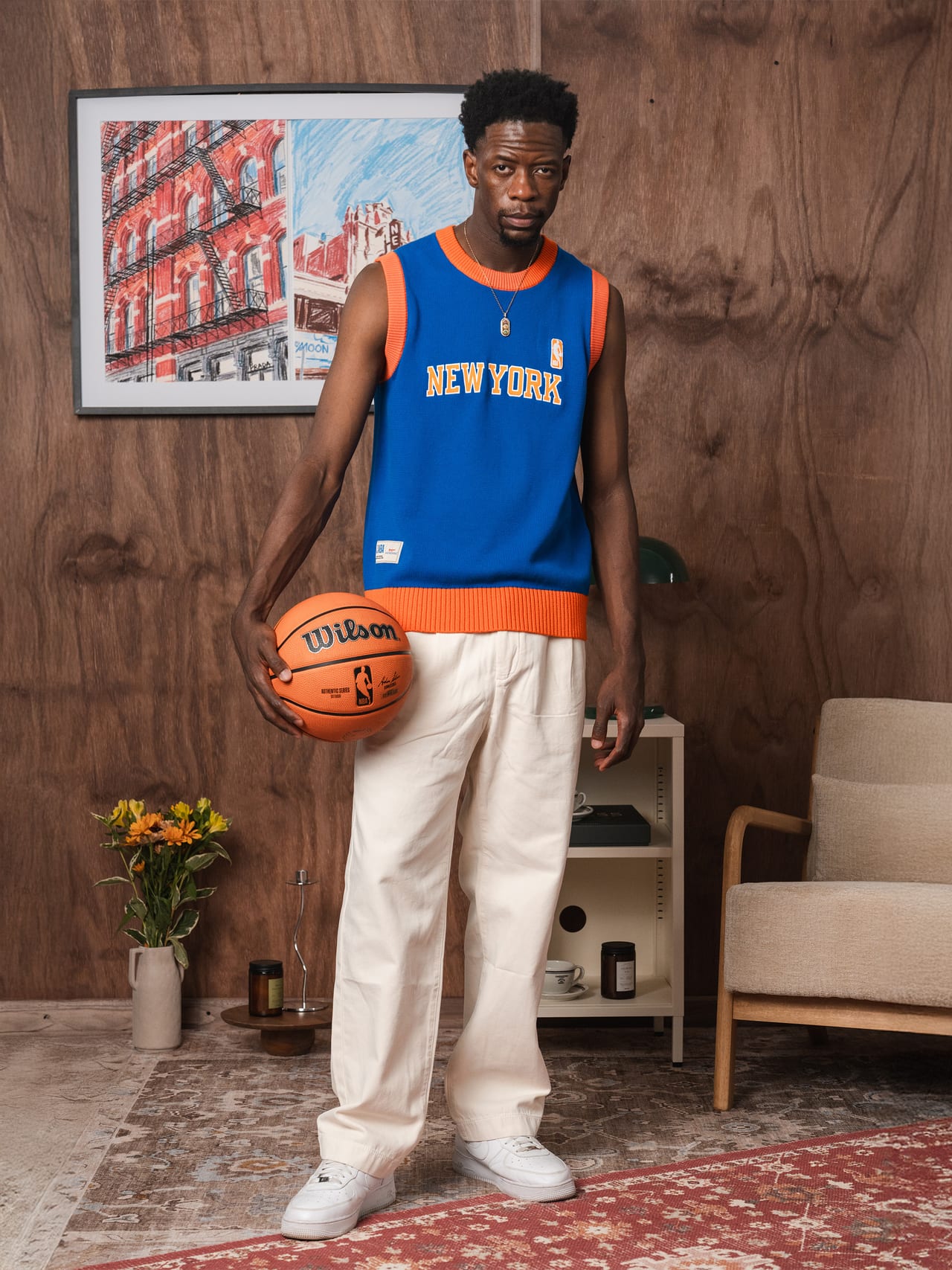 Knicks vest worn on talent, holding a basketball