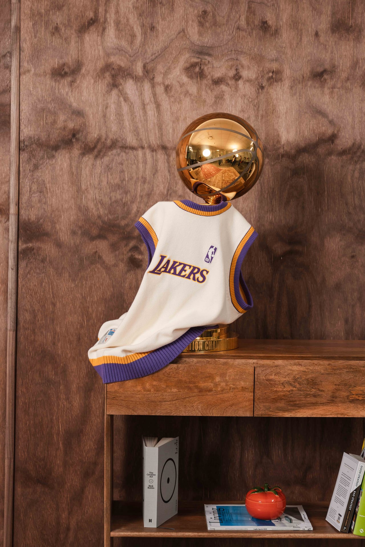 Lakers vest and trophy on a wooden console