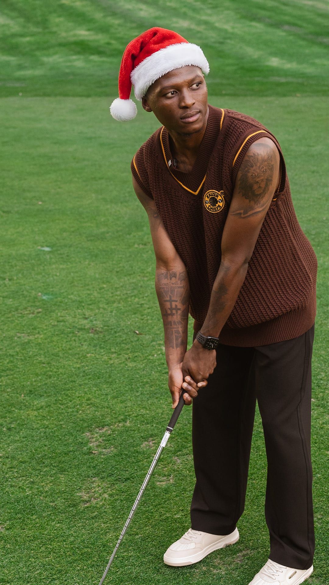 Chiefs vest and Santa hat on a putting green