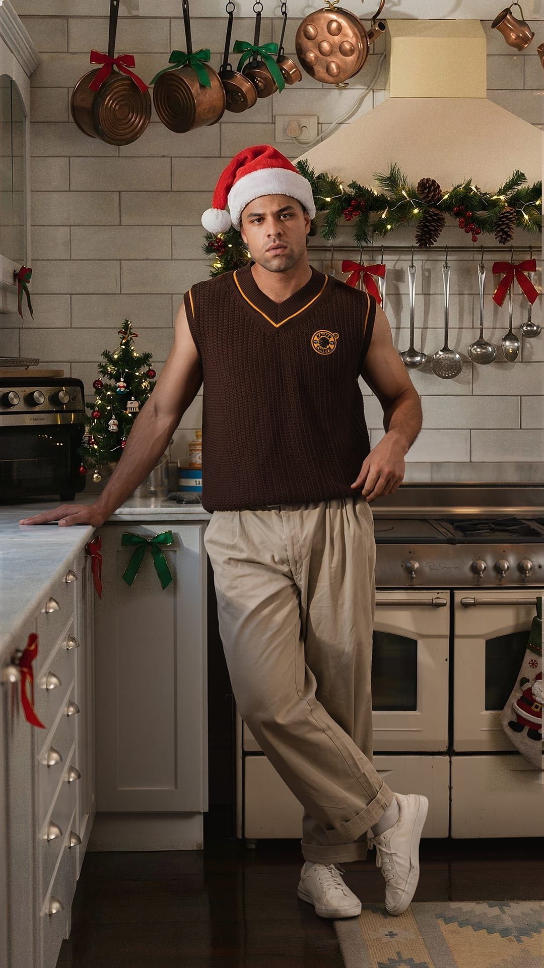 Chiefs vest and Santa hat in a decorated kitchen with copper pots